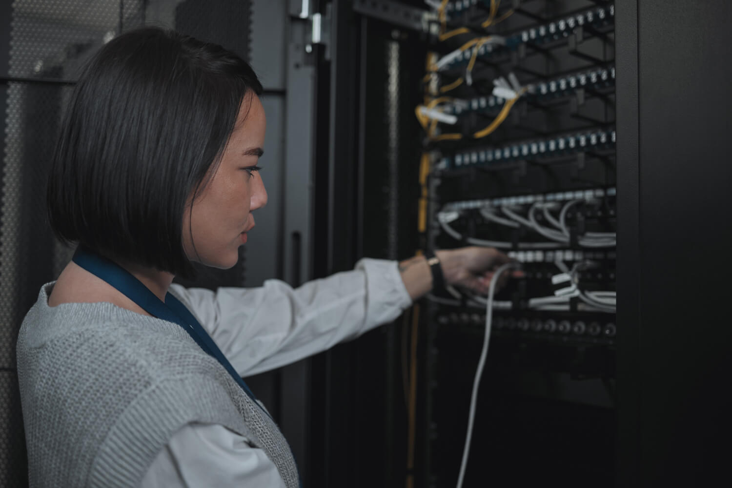 Asian woman, technician and server room for cabling, networking or system maintenance at office. Fe.